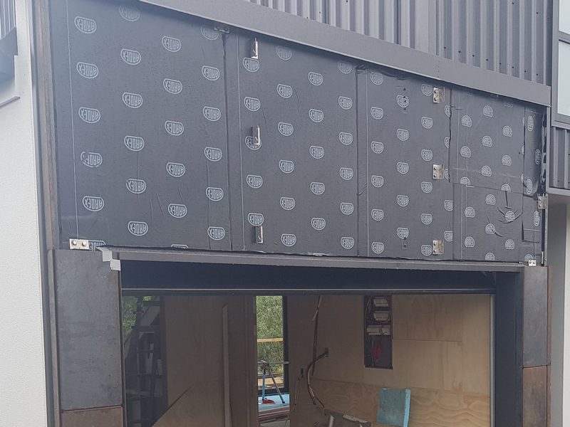 corten rain screen install with vapour barrier over plywood